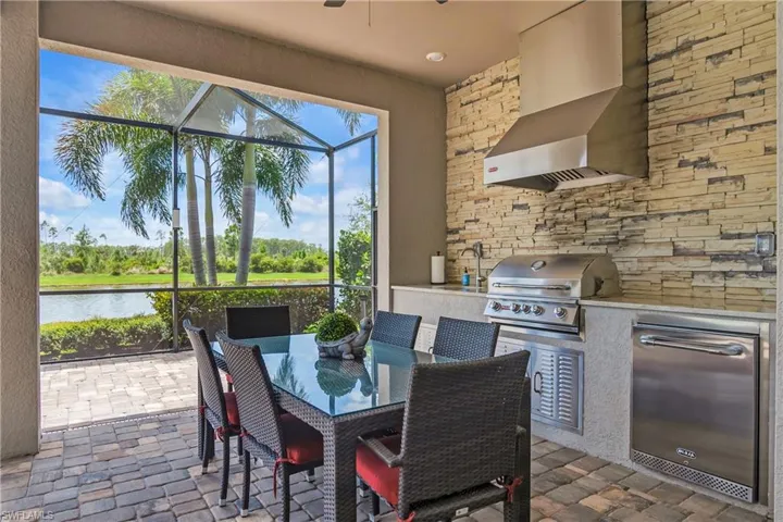 Enjoy preparing meals and dining outdoors with natural gas grill, sink, and beverage cooler.