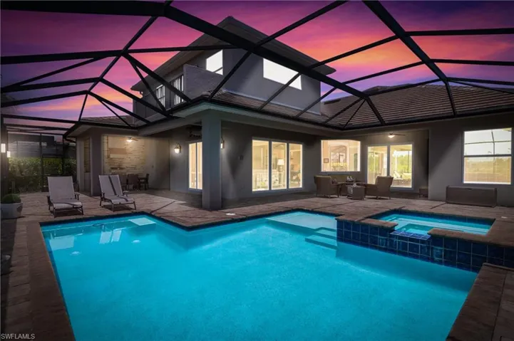 Oversized outdoor lanai and living space includes pool, spa, outdoor kitchen and pool bath.