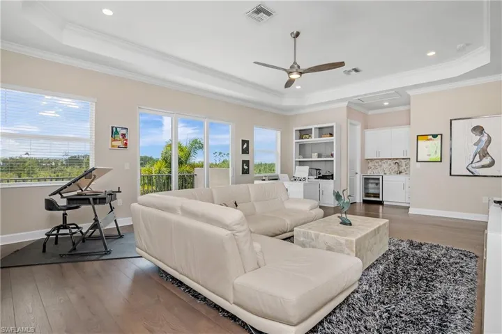 Check out this BONUS ROOM in the loft! It is HUGE and includes a large closet, a kitchenette with a beverage cooler and sink, an additional full bath, a private BALCONY, and so much natural light! This is perfect for your guests, or can serve as a home theatre, hobby room, game room for the kids, or even another master suite!