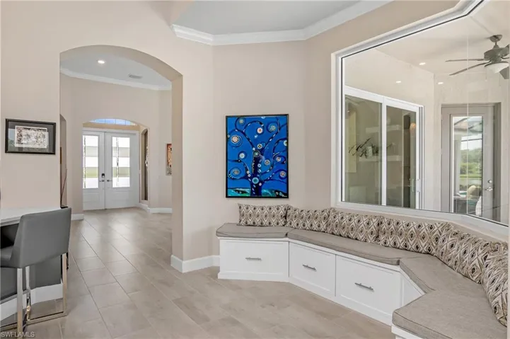 Custom cabinetry and window bench seating complement the kitchen cafe space.