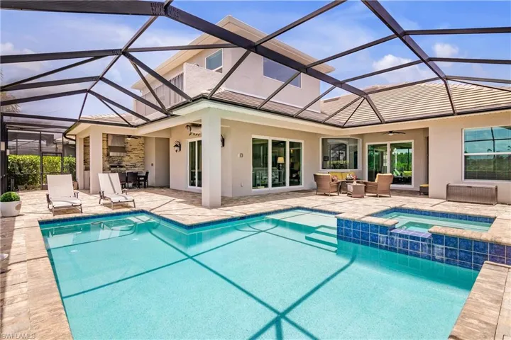 Relax at this FABULOUS outdoor living space featuring an "L" shaped pool with sun shelf and spa, outdoor kitchen, and plenty of room for enjoying time with family and friends. Note the bonus room on the second level with the additional balcony, offering AMAZING sunset views of the canal and protected preverve.