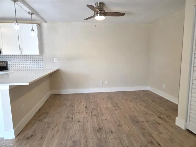 Open-concept living space with wood-finish flooring