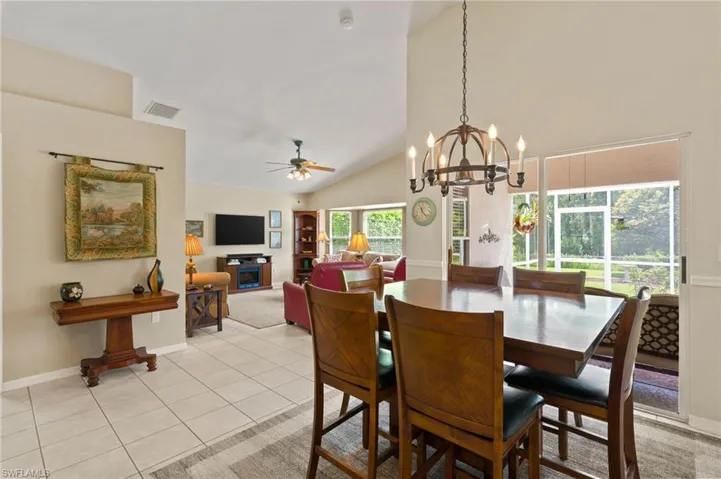 Dining area with Slider to Lanai. Chandelier and Tiled floors
