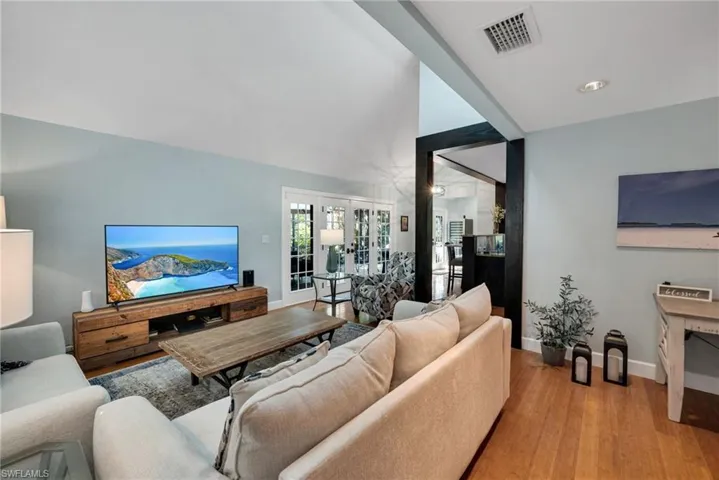 Living room with light hardwood / wood-style flooring and french doors