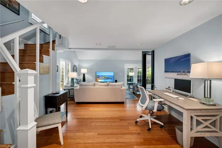 Office with light hardwood / wood-style flooring