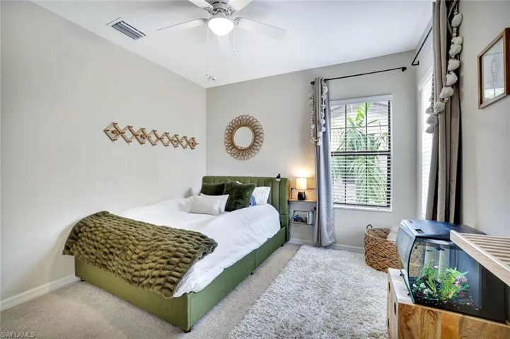 Guest Bedroom with plenty of natural light and ceiling fan.
