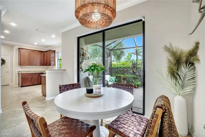 Dining area featuring tile floors, crown molding and a lot of natural light.
