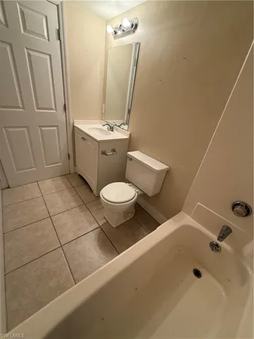 Full bathroom with tile patterned flooring, a bath, and vanity