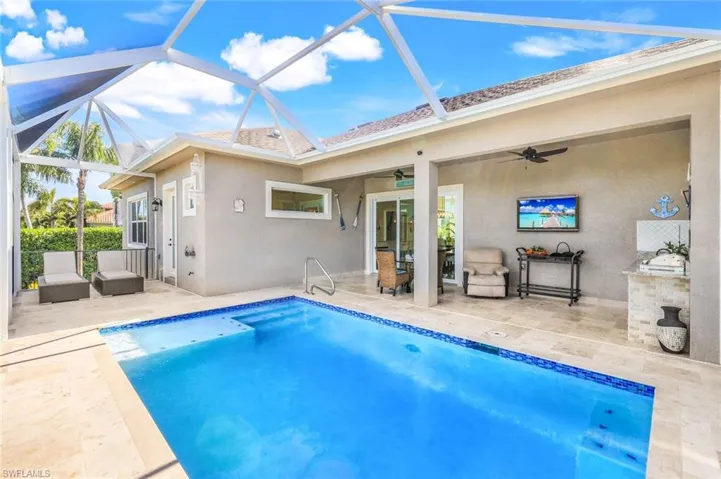Swimming pool with a sunroom, a patio area, a ceiling fan, a lanai, and an outdoor living space