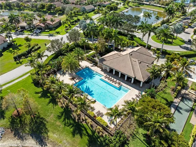 Bird's eye view of a nearby body of water and a pool