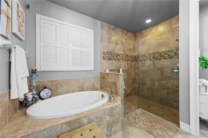 Full bath with a bath, walk in shower, and recessed lighting