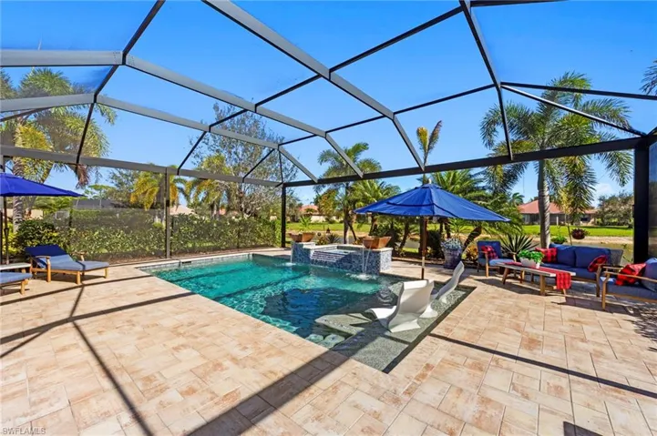 View of pool with glass enclosure, a sunroom, a pool with connected hot tub, and an outdoor hangout area