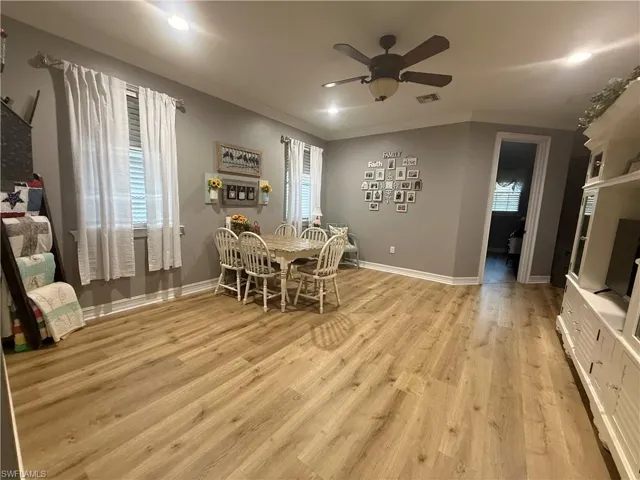 Dining area with ceiling fan, light wood-style floors, recessed lighting, and ornamental molding