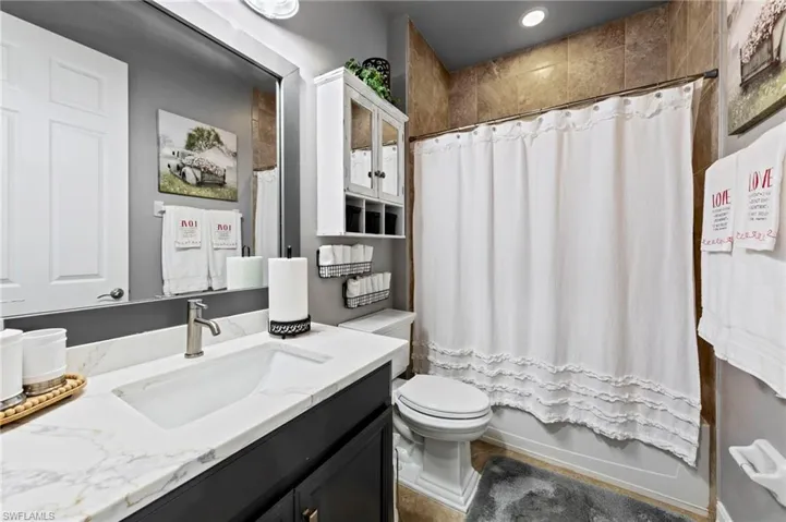 Full bath featuring vanity and shower / tub combo