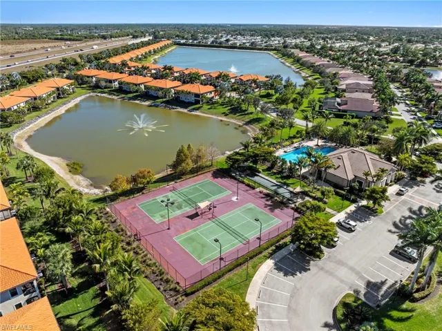 Aerial view of residential area featuring a nearby body of water