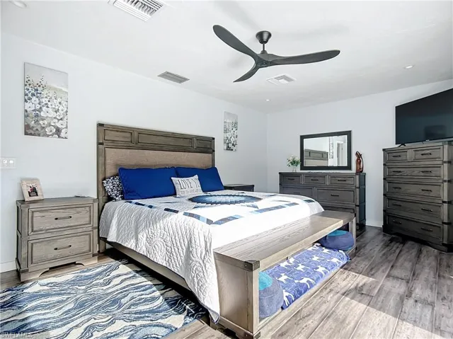 Primary Bedroom featuring designer ceiling fan, bamboo floors, and recessed lighting