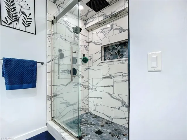 Primary Bathroom with a designer tile shower and multiple shower heads