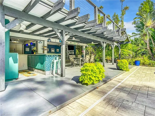 View of patio featuring a bar and outdoor dining area