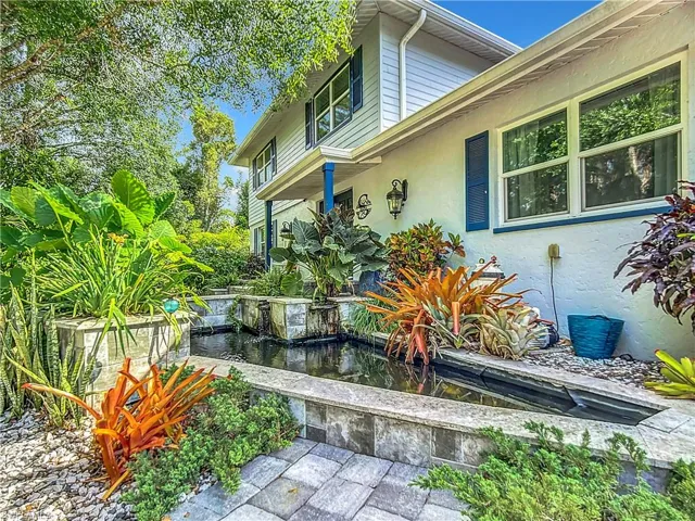 View of front entry featuring fish pond