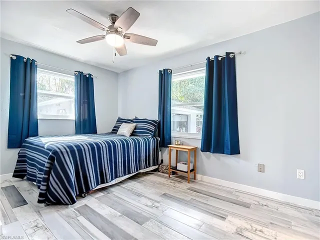 4th bedroom featuring multiple windows, and a designer ceiling fan,