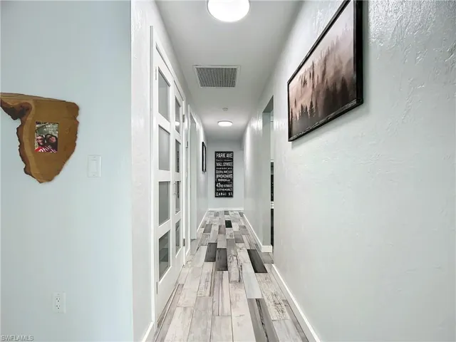 Downstairs Hallway with doors to kitchen pantry