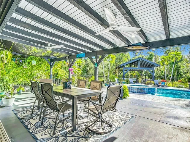 Covered patio overlooking pool/hot tub and pavillon