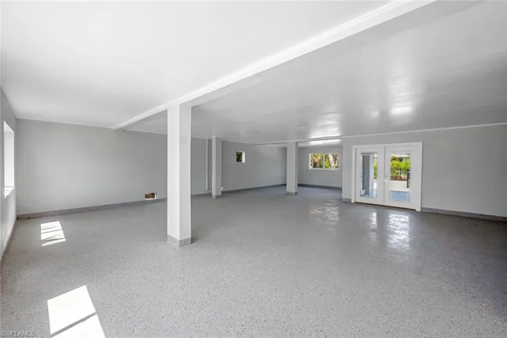 Unfurnished room with french doors and speckle patterned floor
