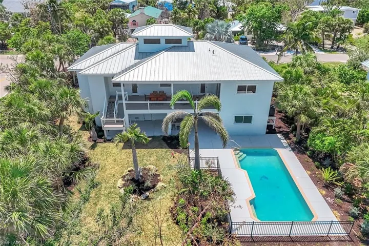Rear view of house featuring a patio, an outdoor pool, stairway, a metal roof, and stucco siding