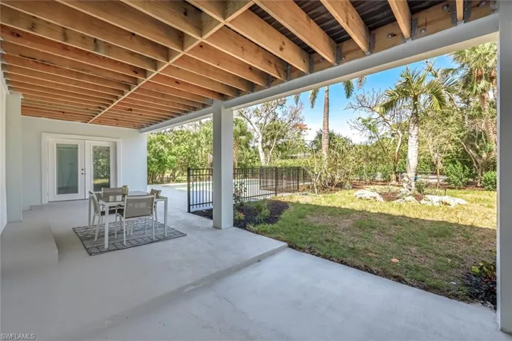 View of patio with french doors and outdoor dining area