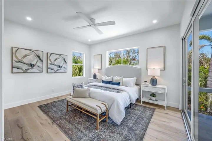 Bedroom featuring light wood-style flooring, baseboards, recessed lighting, and a ceiling fan