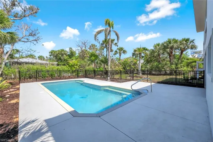 View of swimming pool featuring a patio and a fenced backyard