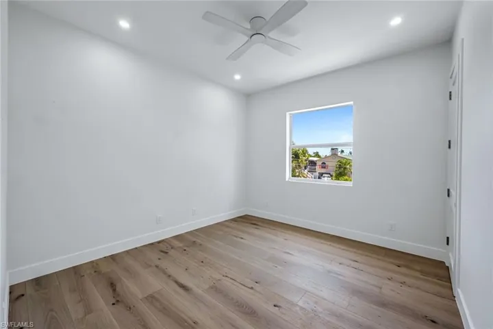 Unfurnished room featuring baseboards, recessed lighting, wood finished floors, and ceiling fan