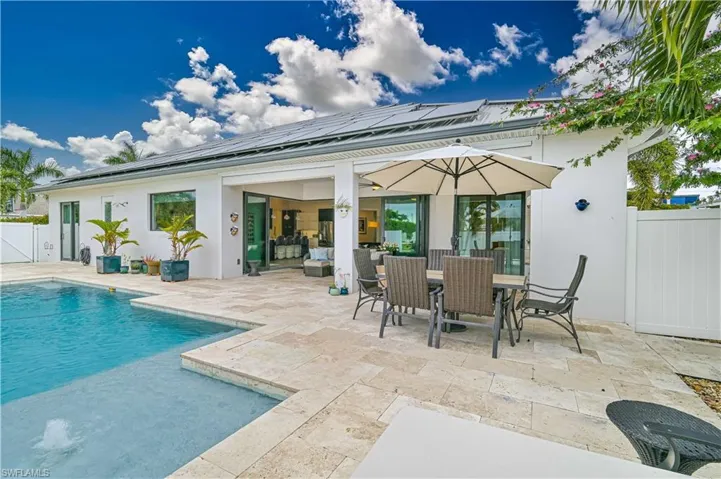 Back of property featuring outdoor dining area, a fenced backyard, a patio area, and stucco siding