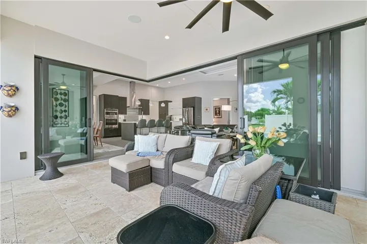 View of patio with ceiling fan and outdoor lounge area