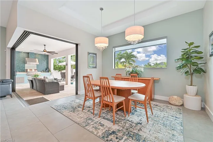 Dining area featuring a raised ceiling and ceiling fan