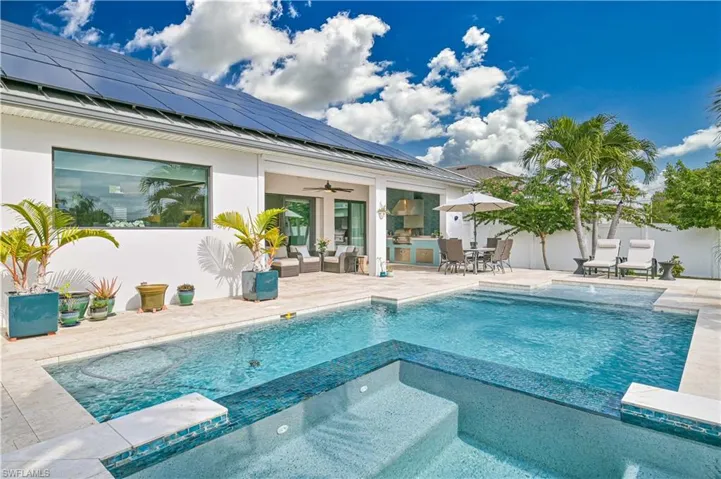 View of swimming pool with a patio, outdoor dining area, an outdoor living space, and a pool with connected hot tub