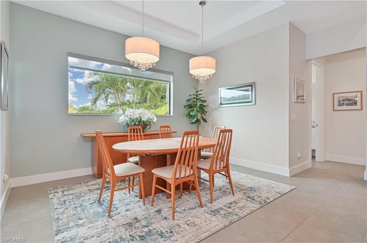 Dining space featuring baseboards and a tray ceiling