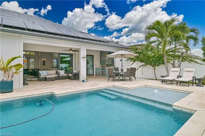 Swimming pool with a patio, outdoor lounge area, outdoor dining space, and a grill