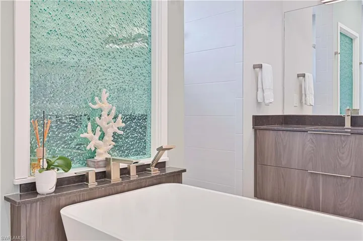 Full bathroom featuring vanity and a freestanding bath