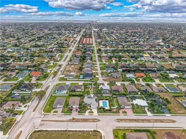 Aerial view of property's location with nearby suburban area