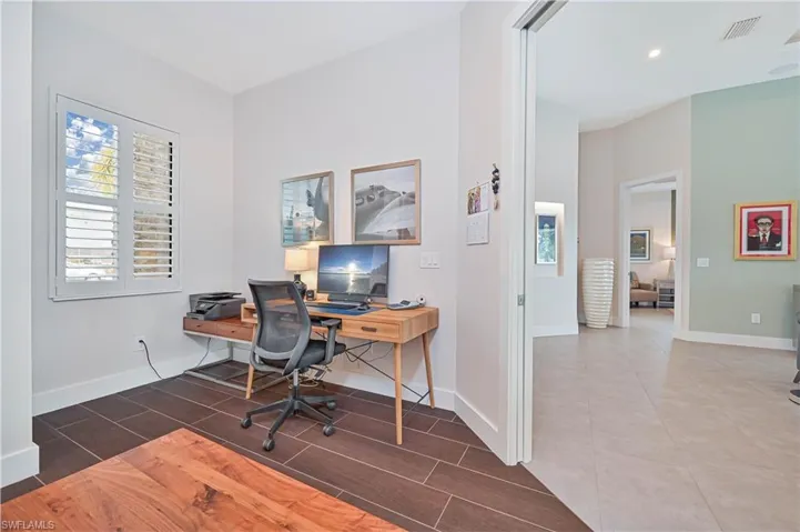 Office space with baseboards and wood finish floors