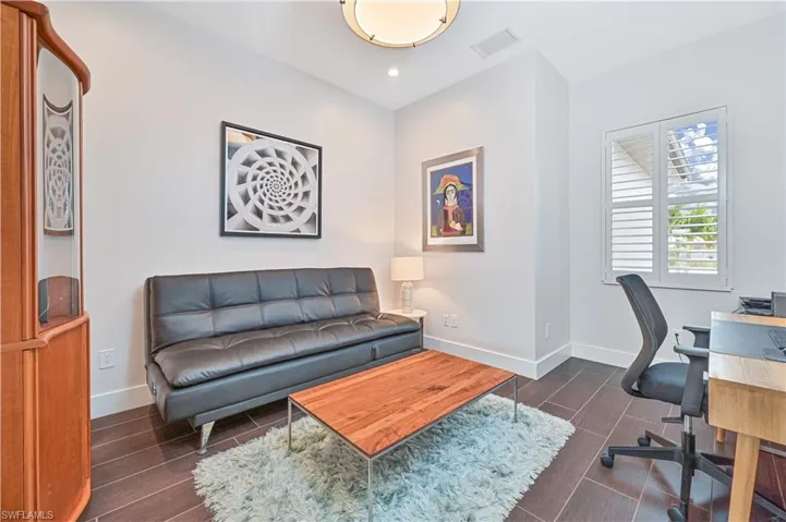 Office space featuring wood tiled floors and recessed lighting