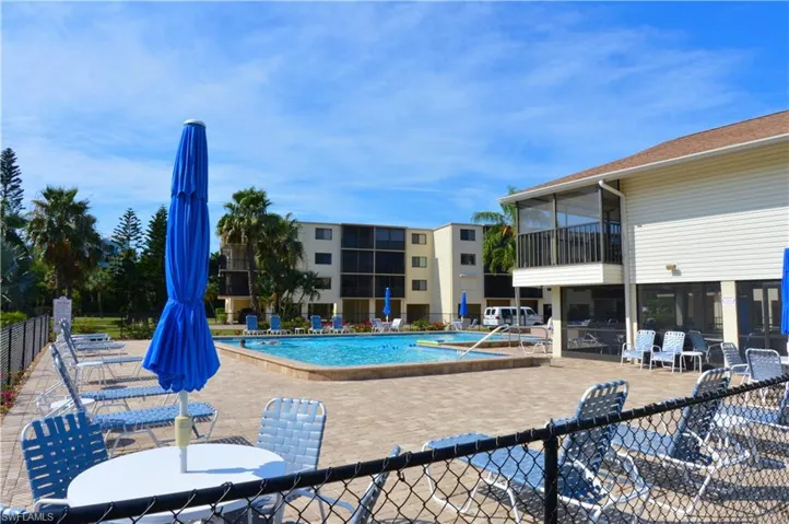 Pool area and community room under elevated condo