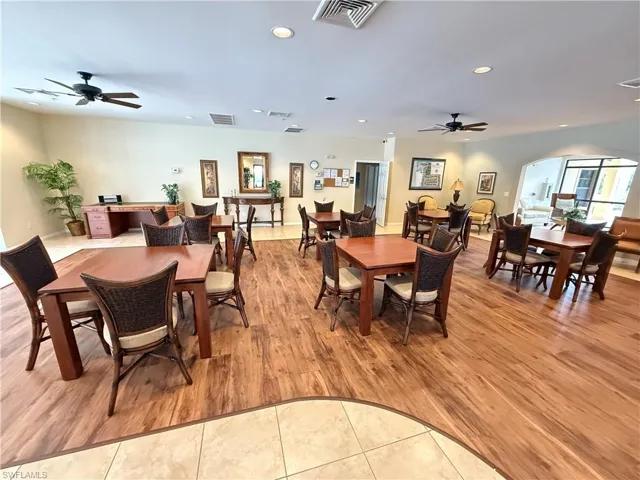 Clubhouse Dining space featuring ceiling fan, light tile patterned floors, arched walkways, and recessed lighting