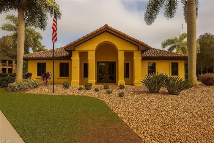 Clubhouse featuring a tiled roof, stucco siding, and a porch