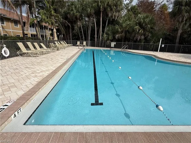 Community pool featuring a patio