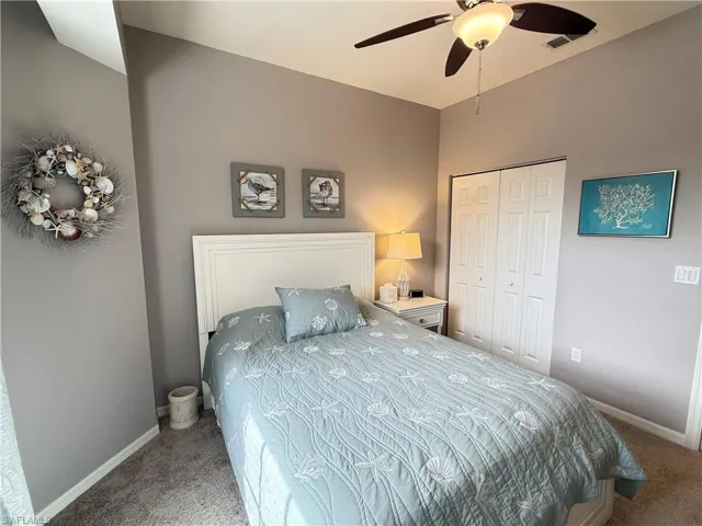 Bedroom with carpet floors, a closet, and ceiling fan