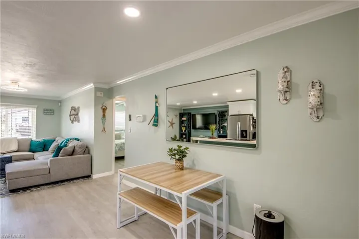 Dining area featuring light hardwood / wood-style floors and ornamental molding