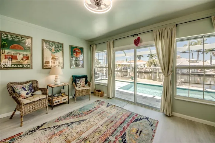Sitting room with light hardwood / wood-style flooring and a water view