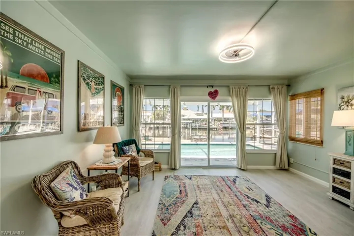 Sitting room featuring light wood-type flooring and crown molding